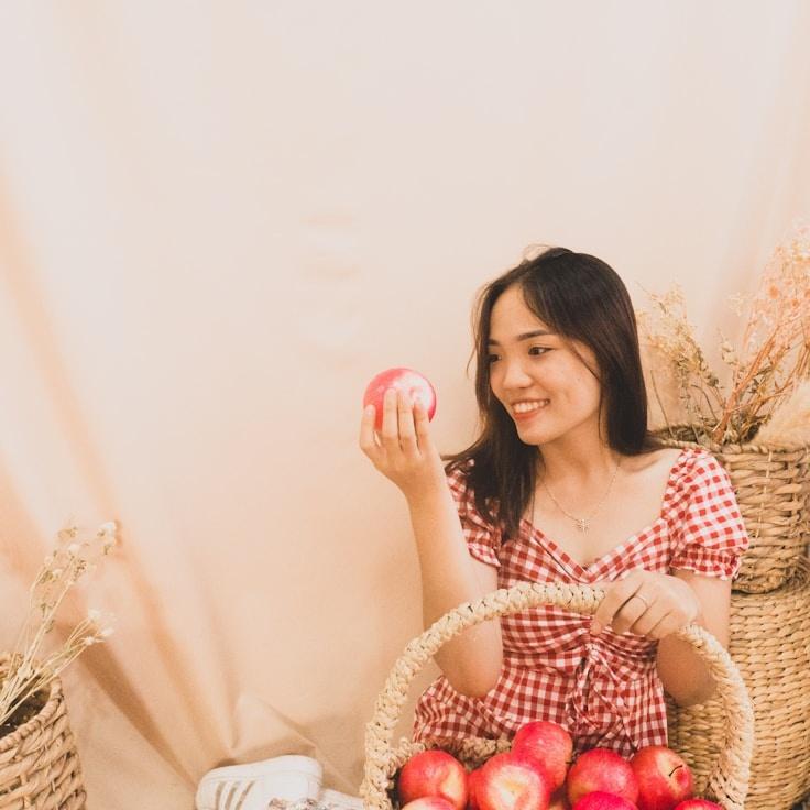 Avery Chen, Lead Design Curator at NeutralGrowthWay, reviewing corporate floral arrangements